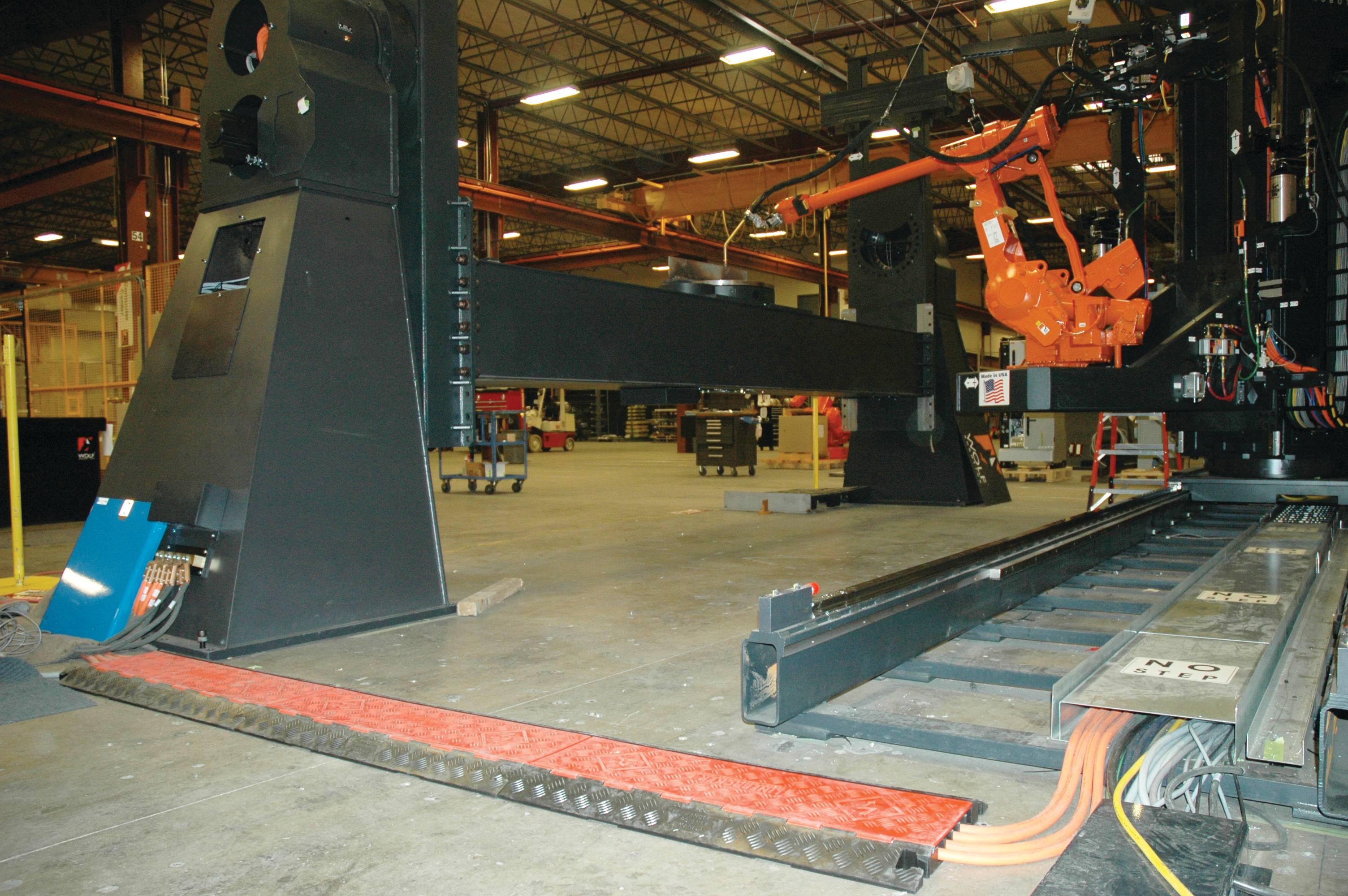 Cable protector in use in manufacturing facility