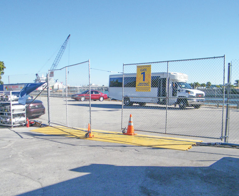 Cable protectors line the ground in front of fencing at an event site
